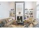 Living room with fireplace, built-in bookshelves, and comfortable seating creates a cozy space for relaxation at 12192 Woods Bay Pl, Carmel, IN 46033