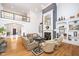 Bright living room with fireplace, hardwood floors, and second story balcony at 12192 Woods Bay Pl, Carmel, IN 46033