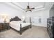 Spacious main bedroom with tray ceiling, ceiling fan, and elegant furnishings at 12192 Woods Bay Pl, Carmel, IN 46033