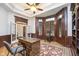 Spacious home office with wood floors, plantation shutters, glass top desk and custom cabinetry at 12192 Woods Bay Pl, Carmel, IN 46033