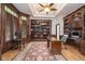 Private office features custom built-ins, rich wood paneling, and ample natural light for a productive workspace at 12192 Woods Bay Pl, Carmel, IN 46033
