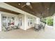 Covered porch with brick columns, ceiling fans, and comfortable seating areas at 12192 Woods Bay Pl, Carmel, IN 46033