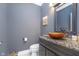 Stylish powder room with elegant vanity, vessel sink, and granite countertop at 12192 Woods Bay Pl, Carmel, IN 46033