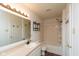 Well-lit bathroom features a shower-tub combo, single sink vanity, and a neutral color palette at 12671 Endurance Dr, Fishers, IN 46037