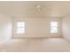 Spacious carpeted bedroom featuring two windows and neutral paint at 12671 Endurance Dr, Fishers, IN 46037