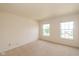 Bright bedroom with neutral carpet has two windows providing lots of natural light at 12671 Endurance Dr, Fishers, IN 46037