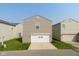 Two-car attached garage flanked by tidy lawn and established neighborhood at 12671 Endurance Dr, Fishers, IN 46037