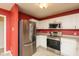Modern kitchen with stainless steel appliances and pristine white cabinets at 12671 Endurance Dr, Fishers, IN 46037