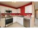 Bright kitchen features stainless steel appliances and clean white cabinetry at 12671 Endurance Dr, Fishers, IN 46037