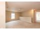 Carpeted loft area featuring neutral paint and natural light from the windows at 12671 Endurance Dr, Fishers, IN 46037