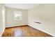 A minimalist bedroom with hardwood floors and a bright window offers a clean and comfortable space at 13172 E 116Th St, Fishers, IN 46037