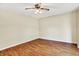 Empty bedroom featuring hardwood floors and neutral-colored walls with a ceiling fan at 13172 E 116Th St, Fishers, IN 46037