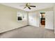 A bright bedroom features neutral walls, carpeted flooring, and a ceiling fan, creating a cozy and inviting space at 13172 E 116Th St, Fishers, IN 46037