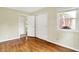 Bedroom featuring hardwood floors, a bright window, and closet space, providing a simple, functional design at 13172 E 116Th St, Fishers, IN 46037