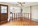 View of the home's entryway featuring hardwood floors and a unique half-wall partition looking into the living room at 13172 E 116Th St, Fishers, IN 46037