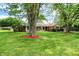Inviting ranch home featuring a large front yard with mature shade trees at 13172 E 116Th St, Fishers, IN 46037