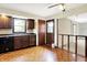 Cozy kitchen with wooden cabinetry, a stainless steel sink, and view of the hardwood flooring in the entryway at 13172 E 116Th St, Fishers, IN 46037