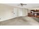 Spacious living room featuring neutral walls, wall-to-wall carpeting, and a view of the kitchen at 13172 E 116Th St, Fishers, IN 46037