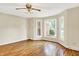 Spacious living room with hardwood floors, a ceiling fan, and bay windows offering natural light at 13172 E 116Th St, Fishers, IN 46037