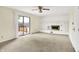 Bright living room featuring a white brick fireplace, sliding glass doors, and neutral carpeting at 13172 E 116Th St, Fishers, IN 46037
