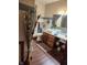 Bathroom with modern vanity, vessel sink, decorative accents, and hardwood flooring at 1322 Greenway Dr, Anderson, IN 46011