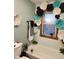 Charming bathroom featuring decorative flowers around the window and plants on the tub at 1322 Greenway Dr, Anderson, IN 46011