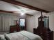 Bedroom with exposed beam ceiling, multiple dressers, closet access, and natural light at 1322 Greenway Dr, Anderson, IN 46011