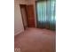 Cozy bedroom with wood door, closet, and green curtains at 1322 Greenway Dr, Anderson, IN 46011