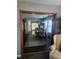 Open dining room with wood floors, a decorative rug, and stylish lighting fixture at 1322 Greenway Dr, Anderson, IN 46011