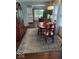 Dining room featuring hardwood floors and a decorative rug, adjacent to the kitchen area at 1322 Greenway Dr, Anderson, IN 46011