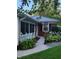 Charming home featuring a welcoming walkway with beautiful landscaping, leading to a cozy sunroom at 1322 Greenway Dr, Anderson, IN 46011