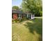 Brick home with sunroom, foundation landscaping, and inviting curb appeal at 1322 Greenway Dr, Anderson, IN 46011