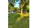 Charming home featuring mature trees, a sunroom, and a sprawling lawn at 1322 Greenway Dr, Anderson, IN 46011