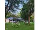 Charming brick home with well-manicured lawn and landscaping, featuring a detached garage and mature trees at 1322 Greenway Dr, Anderson, IN 46011