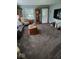 Cozy living room with plush carpet, natural light, and comfortable seating arrangement at 1322 Greenway Dr, Anderson, IN 46011