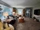 Inviting living room with neutral tones, large windows, and comfortable furniture arrangement at 1322 Greenway Dr, Anderson, IN 46011