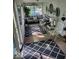 A bright sunroom featuring cozy seating, decorative rugs, and ample natural light at 1322 Greenway Dr, Anderson, IN 46011