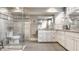 Modern bathroom with a frameless glass shower, dual sinks, and beautiful white cabinetry at 140 4Th Nw St, Carmel, IN 46032
