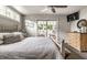 Cozy bedroom with access to a patio, featuring a ceiling fan and lots of natural light at 140 4Th Nw St, Carmel, IN 46032