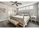 Comfortable bedroom with a decorative bed frame, ceiling fan, and natural light from the windows at 140 4Th Nw St, Carmel, IN 46032