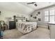 Comfortable bedroom with a ceiling fan, neutral decor, and a side table with a lamp at 140 4Th Nw St, Carmel, IN 46032