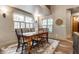 Dining room with large windows, rustic wooden table and decorative rug at 140 4Th Nw St, Carmel, IN 46032