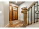 A well-lit foyer showcases a beautiful wood door and hardwood floors at 140 4Th Nw St, Carmel, IN 46032