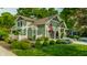 Landscaped lawn in front of inviting craftsman home with beautiful pergola and flowers at 140 4Th Nw St, Carmel, IN 46032