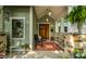 Inviting front porch area with stone pillars, cozy bench, and lovely ferns at 140 4Th Nw St, Carmel, IN 46032
