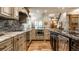 Well-lit kitchen featuring stainless steel appliances, granite countertops and decorative backsplash at 140 4Th Nw St, Carmel, IN 46032