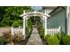 Scenic stone path through landscaped garden with a white pergola and a picket fence at 140 4Th Nw St, Carmel, IN 46032