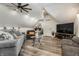 Inviting living room with comfortable seating, wood floors, a ceiling fan, and a TV at 140 4Th Nw St, Carmel, IN 46032
