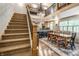 Open concept living room with staircase, dining area, and modern kitchen in the background at 140 4Th Nw St, Carmel, IN 46032