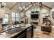 Gourmet kitchen with island opens up to a cozy living area with a stone fireplace at 140 4Th Nw St, Carmel, IN 46032